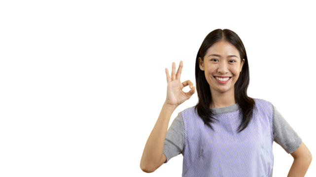 Young asian woman over PNG backgroung doing ok sign with hands, OK symbol, Welcome, Agree, Join, Do as instructed, Follow orders, Acceptance of all conditions.