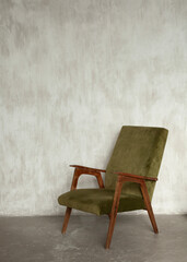 green cozy vintage armchair on a white wall background
