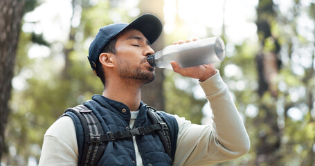 Water, drink and man with fitness hiking, exercise and thirsty in forest, nature and woods....