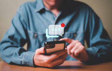 Selective focus at men hand while type on smartphone while chat and communication with friend on online social media platform. Virtual community that people can share or upload photo and content.