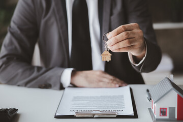 House sales representatives, sales representatives recommend housing details in the project to customers who are interested in viewing the houses in the project. Real estate trading concept.