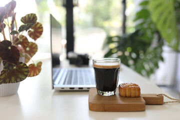 Laptop side view and coffee glass mug and dessert indoor working