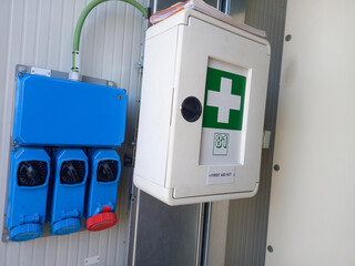 Electric Power socket with first aid box on the wall.
