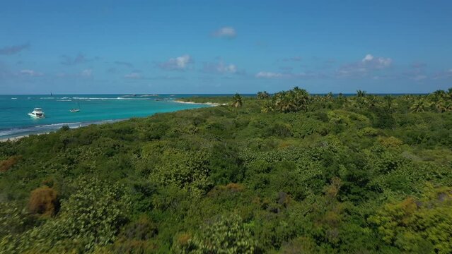 Aerial Drone view flying over trees, beach and turquoise water on a caribbean island. At Cayo Icacos Puerto Rico