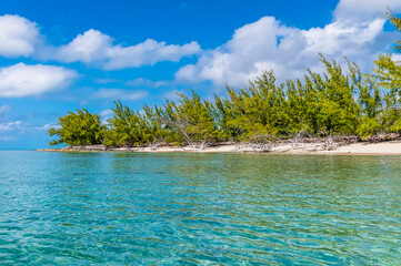 A view along the shore of a deserted bay on the island of Eleuthera, Bahamas on a bright sunny day