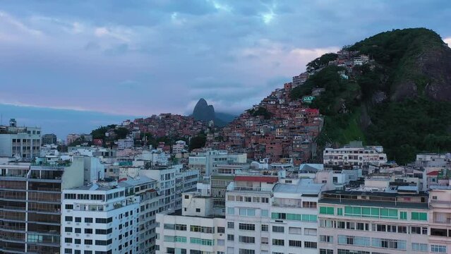 Cantagalo and Pavao-Pavaozinho Favelas on Cloudy Morning. Rio de Janeiro, Brazil. Aerial View. Drone Flies Upwards, Tilt Down. Crane Shot