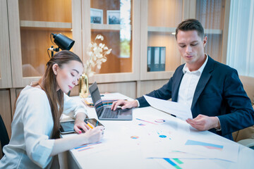 Portrait of Young businessman and female secretary meeting in the office. Business success concept.