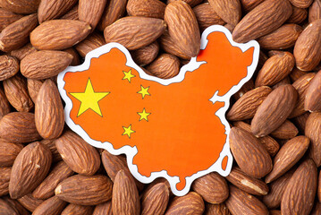 Paper map and flag of China on almond nuts. Concept of growing almond in China, origin of almond