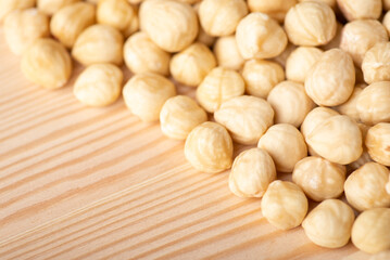 Close up of peeled hazelnuts on wooden background. Tasty white hazelnuts on the table
