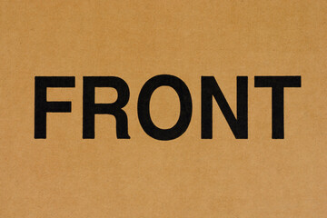 Cardboard paper with the word FRONT printed in black ink.