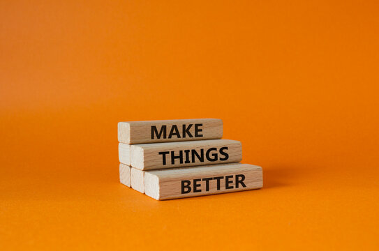 Make things better symbol. Concept word Make things better on wooden blocks. Beautiful orange background. Business and Make things better concept. Copy space