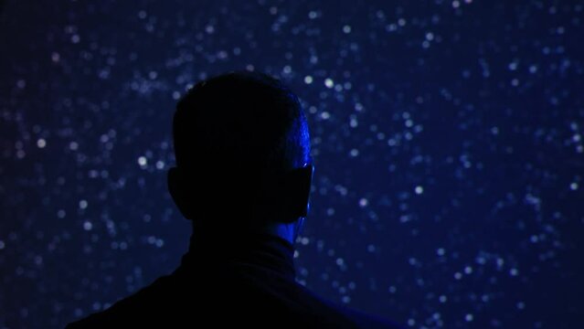 Silhouette of a man with Milky Way starry skies.	
