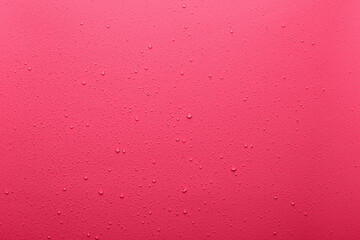 Water drops on coral  color  surface