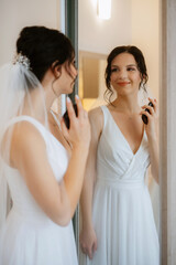 Fototapeta premium preparations for the bride with the dressing of the wedding dress