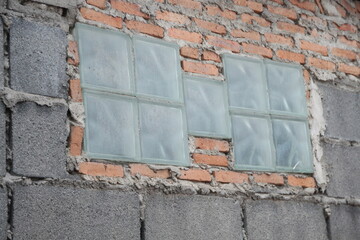 brick wall with windows - Mirror on a brick wall being built