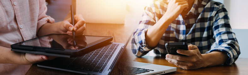 Shot of two businesswoman working together on digital tablet. Creative female executives meeting in an office using tablet pc and smiling.