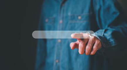 Selective focus at the search box with blurred background of men hand and laptop with internet router while search for information from internet and website. SEO and search engine for online marketing