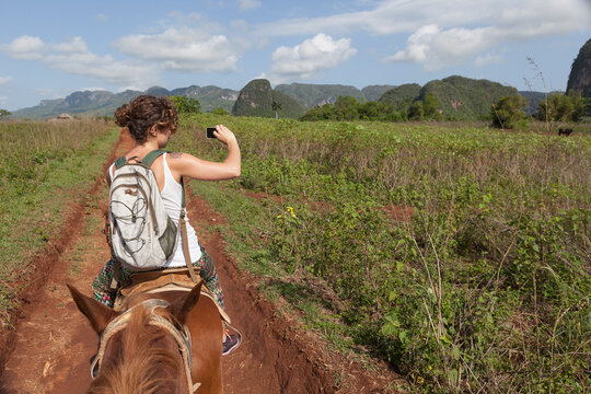 Girl riding a horse in Vinales region in Cuba