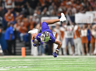 Football player making a great play during a competitive football game