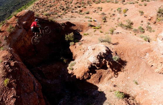 Mountain Biker jumping off a desert cliff.