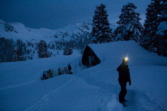 A skier takes pictures around the Elfin Lakes Hut at dawn in Garibaldi Provincial Park, British Columbia, Canada.