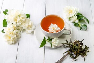 Jasmine tea in a cup on a wooden background