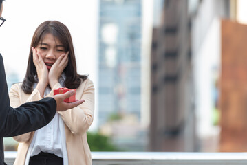 businesswoman and boss show red heart in hands for romantic date at valentine. Two lover holding red present paper symbol for show love. Couple partner friend happy in valentine day.