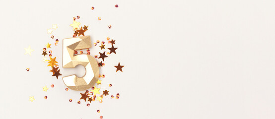 Banner with gold colored number five and shiny stars confetti on a gray background. Festive shiny...