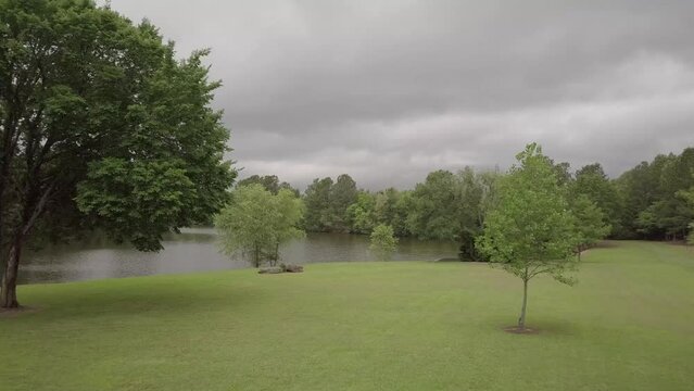 Drone Flies Up and Over River and Forest
