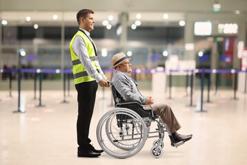 Male assitance worker with a senior passenger in a wheelchair at the airport - obrazy, fototapety, plakaty