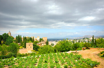 Fototapeta na wymiar Orchards and gardens of the Generalife with the Alhambra and the city of Granada in the background, Andalusia, Spain. World Heritage by unesco