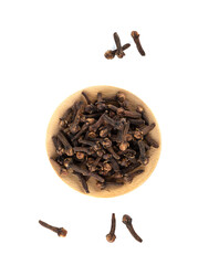 Top view of spice cloves on a wooden plate and on a white background.
