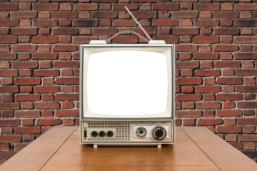 Vntage portable television with wood table, brick wall and empty cut out screen.