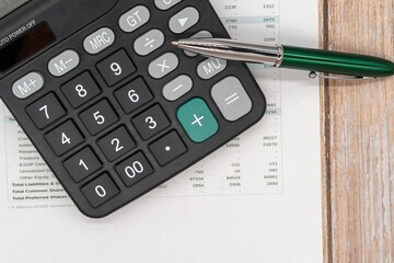 The concept of an accounting audit. calculator and magnifying glass on the financial statement and...