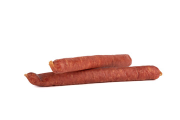 Two thin half-smoked sausages on a white background.