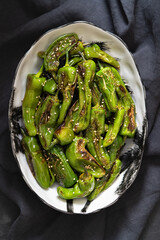 Roasted Shishito Peppers, with salt una sesame seeds. Top view.