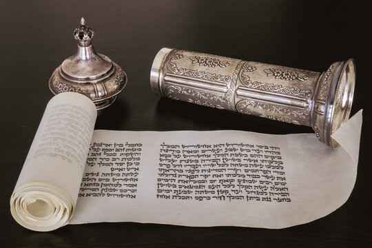 Open Megillat Esther (Book of Esther) isolated scroll on black backround and silver case. Read on the Jewish holiday of Purim.