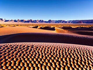 Fototapeta premium A desert with sand dunes and mountains in the distance.