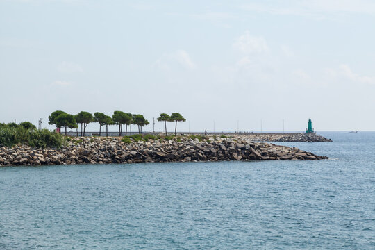 The lighthouse in the pier of Oneglia, the low district of the town of Imperia in west Riviera or Riviera of flowers in Liguria, Italy.