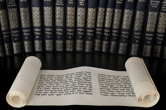 Megillat Esther (Book of Esther) isolated scroll on black backround and talmud. Read on the Jewish holiday of Purim.