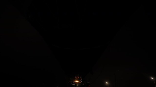 Fire from gas jet burner inflating hot air balloon during outdoor aerostat festival at night - flame rising in dark