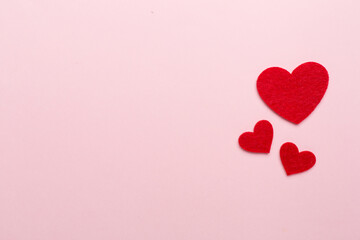 Felt hearts on color background, top view