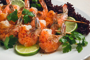 Shrimp kebab, with spices, lime, on wooden skewers, top view, no people,