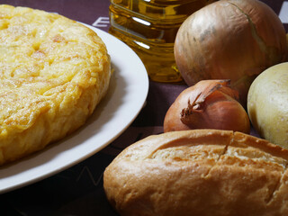 Ingredients and products to make homemade potato and onion omelette, typical of Spain.