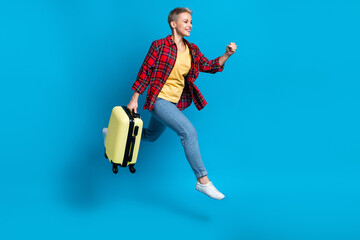 Full body length photo size of tourist passenger running fast hold bags with clothes want adventures active jump isolated on blue color background