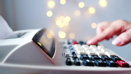 closeup keys and display of the calculator, female hand presses the buttons of the stationary Cash Register, counts and calculates counting operations, small family business concept
