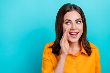 Fototapeta premium Photo of funny excited woman dressed orange shirt arm mouth looking empty space isolated teal color background