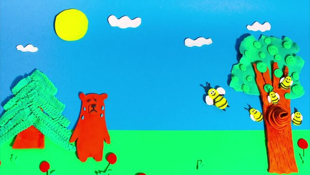 Stop motion animation from plasticine. Bees attack a bear near a beehive in a tree. Claymotion cartoon