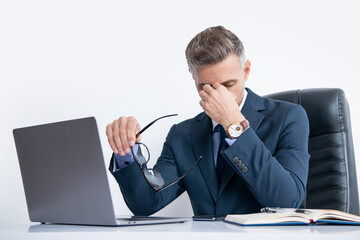 mature tired businessman sitting in business office