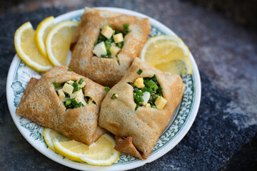 pancakes with fresh green onions and egg on a wooden background